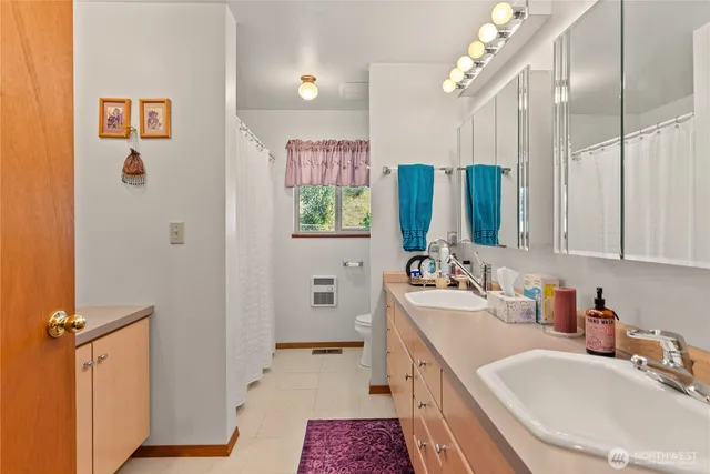 a bathroom with a double vanity sink mirror and double