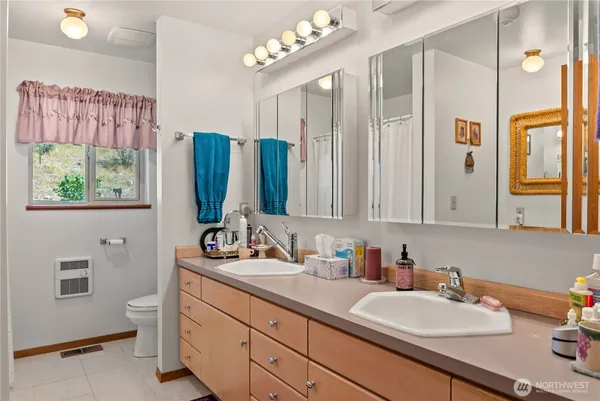 a bathroom with a double vanity sink mirror and double