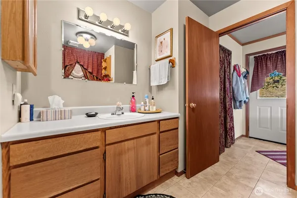 a bathroom with a sink vanity and a mirror