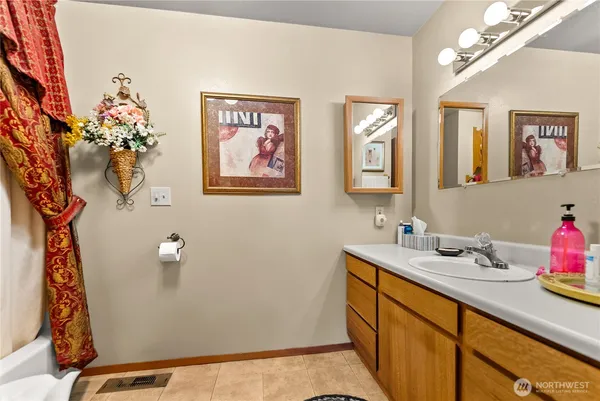 a bathroom with a sink mirror and vanity