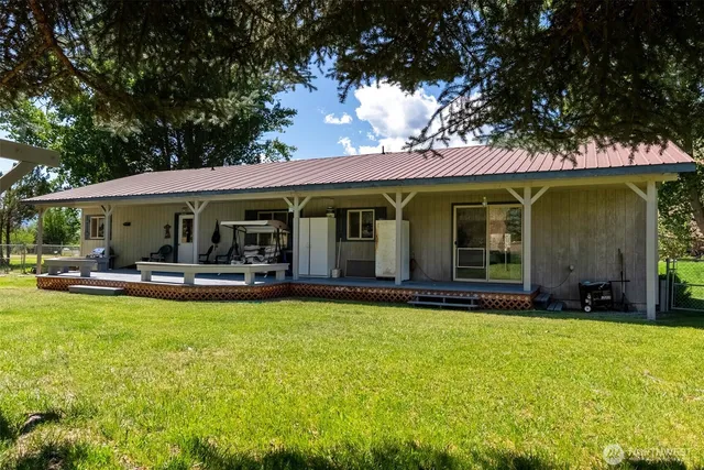 a view of a house with swimming pool and sitting area