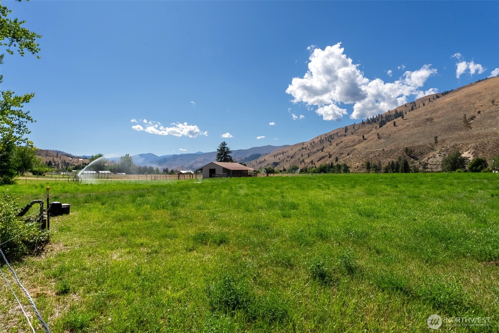 54 B Ross Road, Unit B Twisp, WA 98856 - Photo 35 of 40 a view of a building in the middle of a field