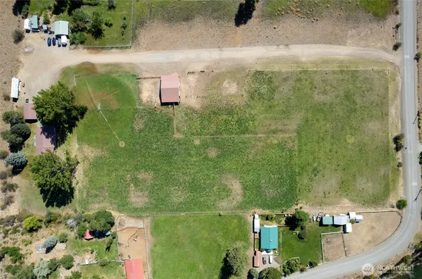 an aerial view of a residential houses with outdoor space
