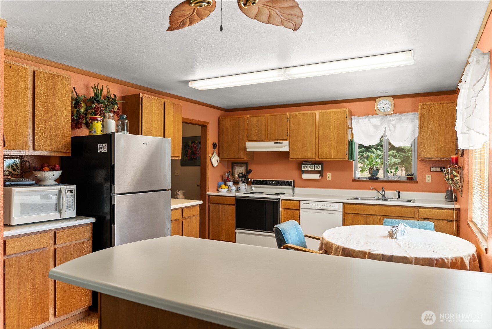 54 B Ross Road, Unit B Twisp, WA 98856 - Photo 5 of 40 a kitchen with stainless steel appliances granite countertop a refrigerator a stove top oven a sink and dishwasher