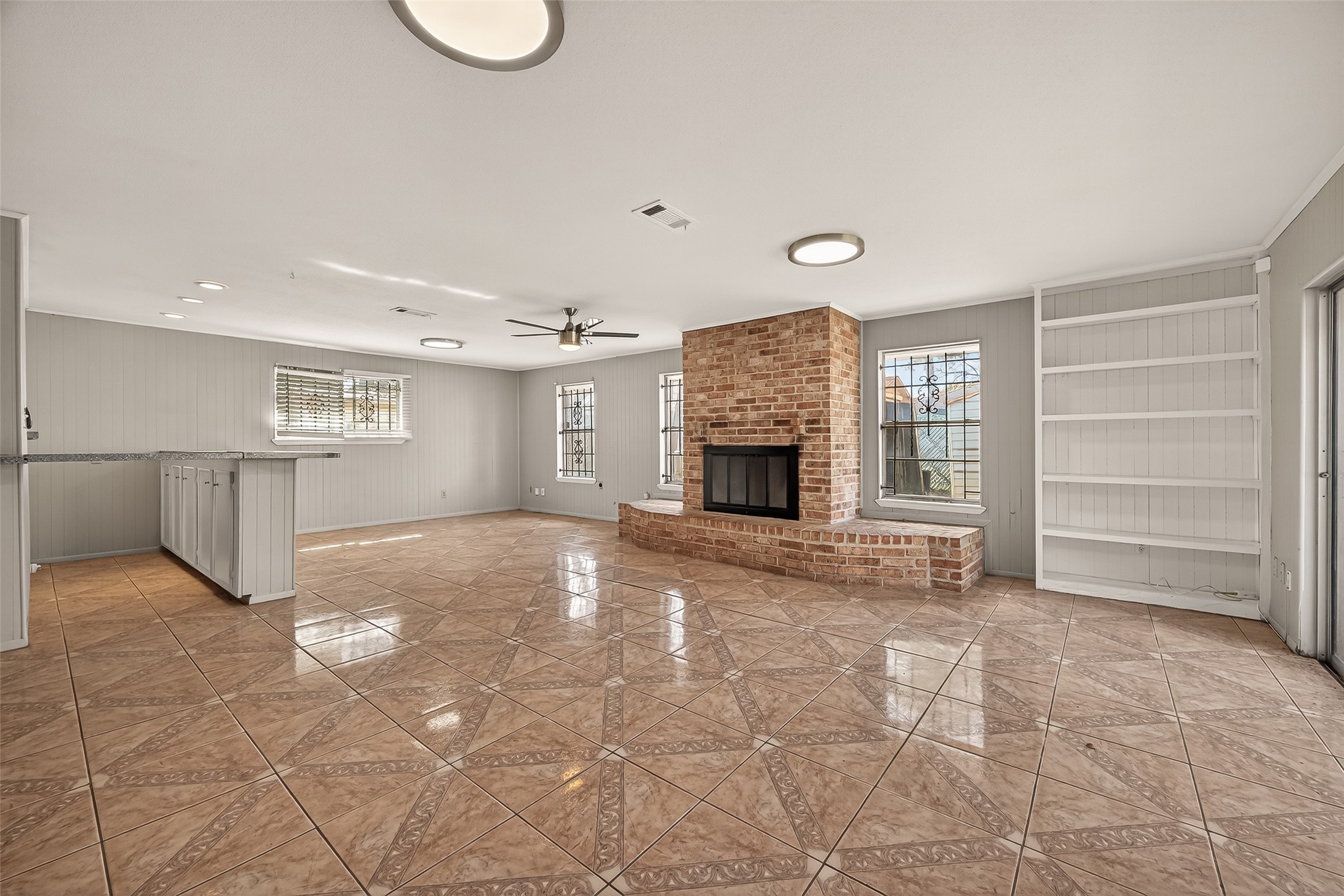 10607 Bainbridge Street Houston, TX 77016 - Photo 13 of 43 a view of an empty room with a fireplace and a window