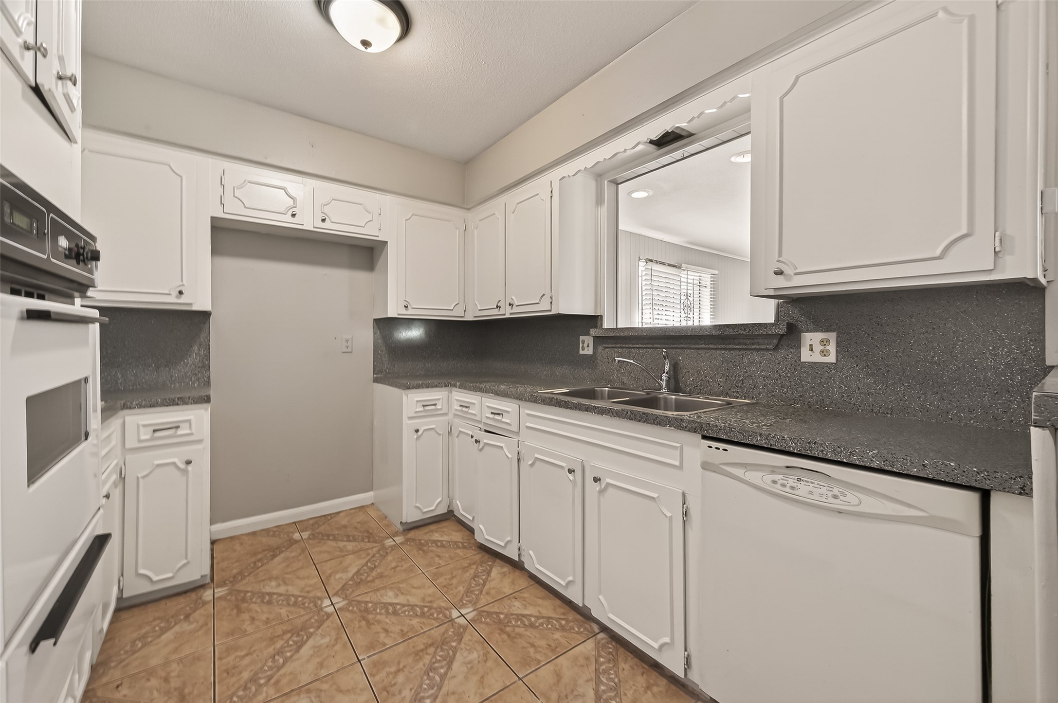 10607 Bainbridge Street Houston, TX 77016 - Photo 18 of 43 a kitchen with granite countertop a sink stainless steel appliances and cabinets