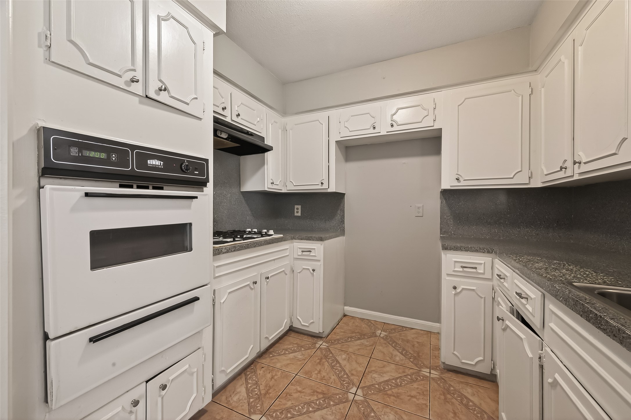 10607 Bainbridge Street Houston, TX 77016 - Photo 19 of 43 a kitchen with granite countertop cabinets stainless steel appliances and a sink