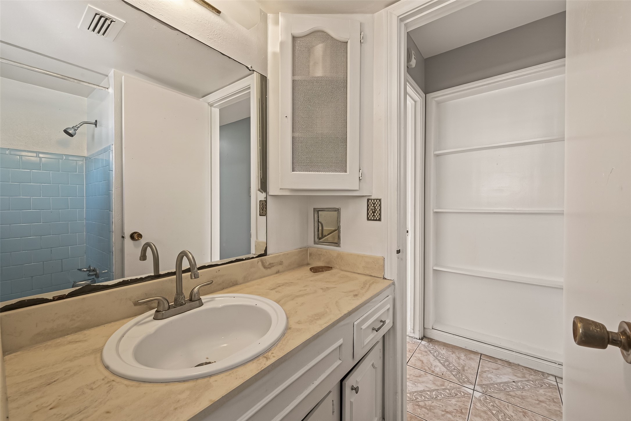 10607 Bainbridge Street Houston, TX 77016 - Photo 36 of 43 a bathroom with a granite countertop sink and a mirror