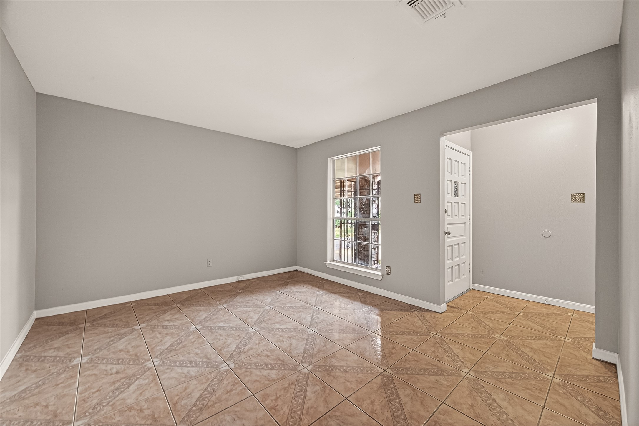10607 Bainbridge Street Houston, TX 77016 - Photo 10 of 43 a view of an empty room with a window