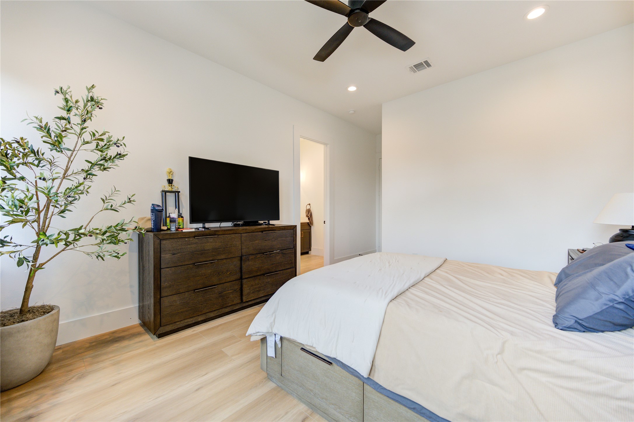 18 Sidney Street, Unit A Houston, TX 77003 - Photo 17 of 30 a bedroom with a bed and a flat screen tv