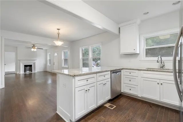 a open kitchen with a white cabinets and fireplace