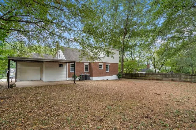 a house that has a tree in front of it