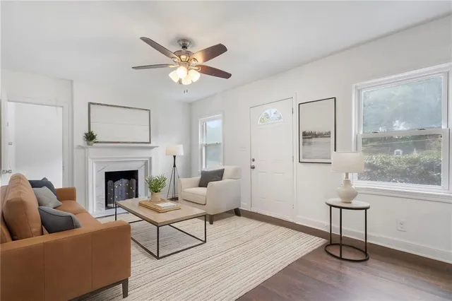 a living room with furniture and a fireplace