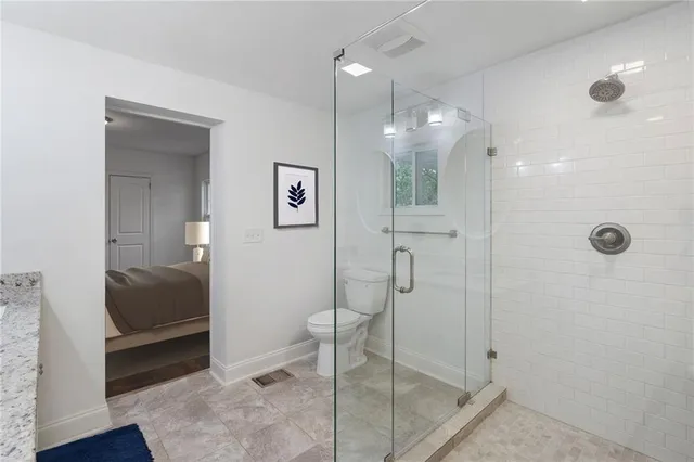 a bathroom with a shower a mirror and a sink