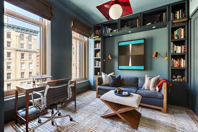 a living room with fireplace furniture and a chandelier
