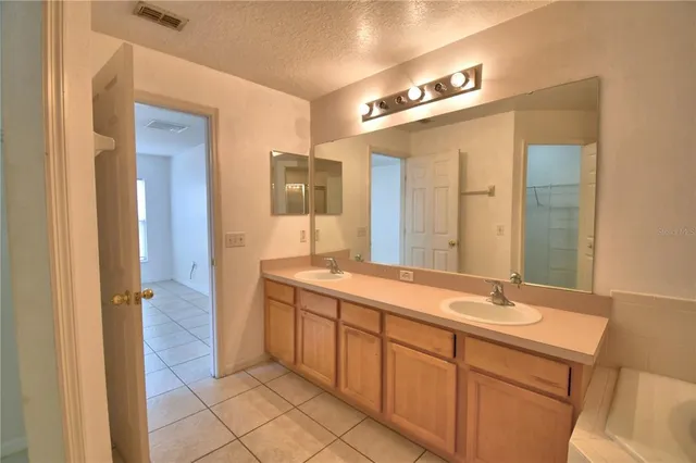 a bathroom with a granite countertop sink mirror and double
