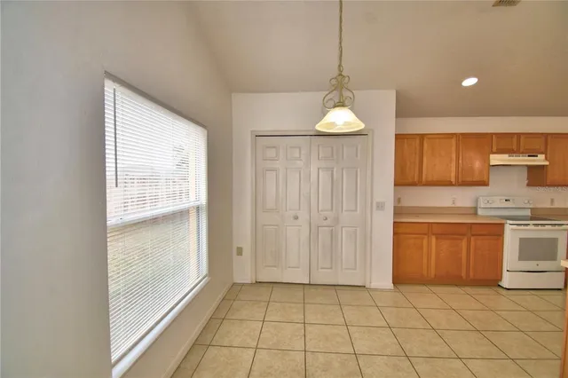 a kitchen with granite countertop a sink cabinets and appliances
