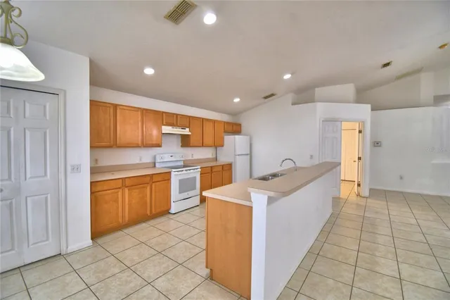 a kitchen with a sink a counter top space and appliances