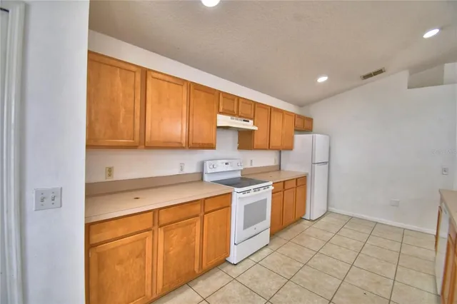 a kitchen with a stove top oven sink and cabinets