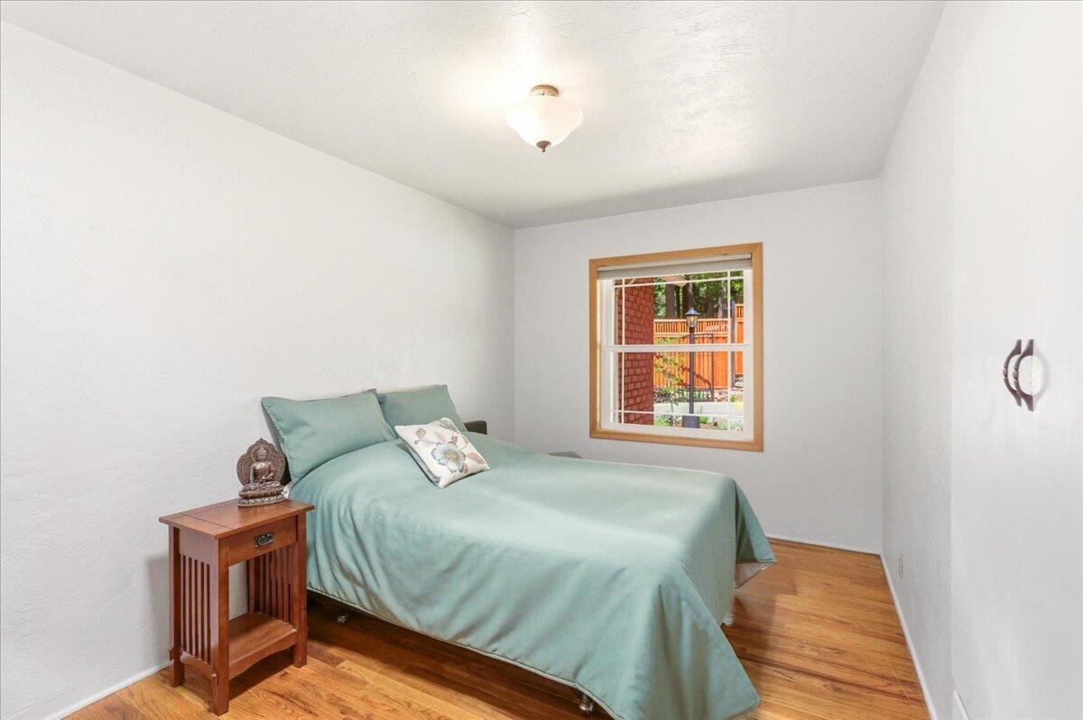 609 Eiler Road Mount Shasta, CA 96067 - Photo 13 of 35 a bedroom with a bed and wooden floor
