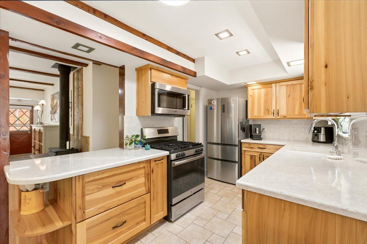 609 Eiler Road Mount Shasta, CA 96067 - Photo 15 of 35 a kitchen with stainless steel appliances a stove microwave and sink