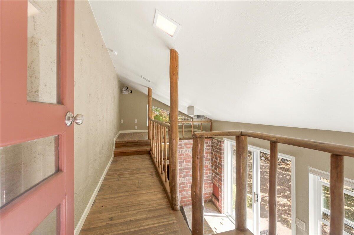 609 Eiler Road Mount Shasta, CA 96067 - Photo 17 of 35 a view of a hallway with wooden floor and staircase