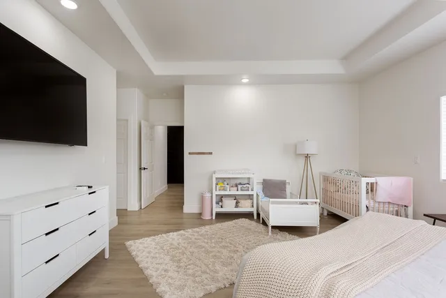 a bedroom with two beds and a flat screen tv