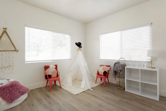 a view of a room with wooden floor and a window