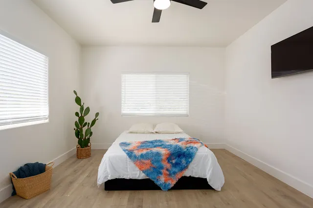 a bedroom with a bed and flat screen tv