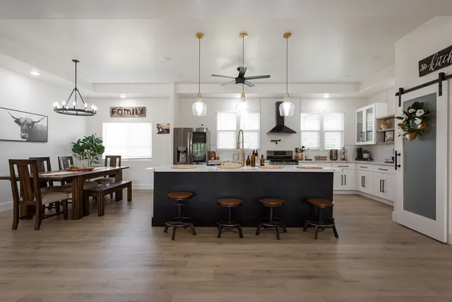 a kitchen with a dining table chairs and view kitchen