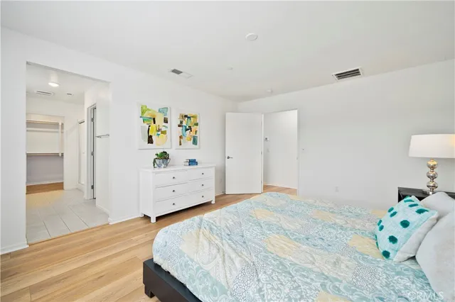 a bedroom with a bed and a dresser