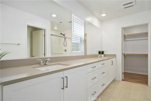 a bathroom with double vanity sink and a mirror