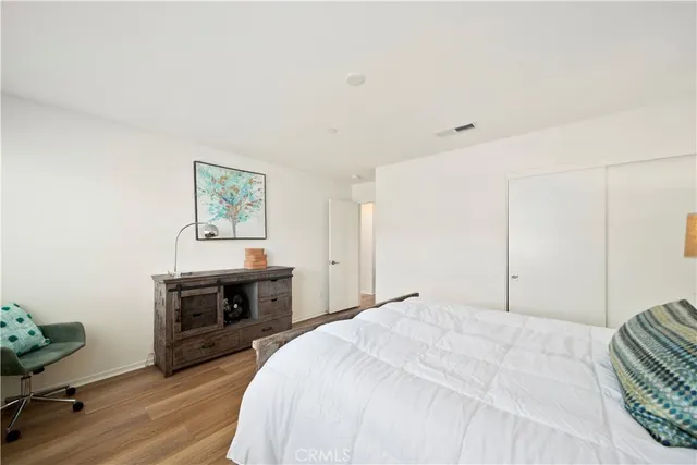 a bedroom with a bed and a dresser