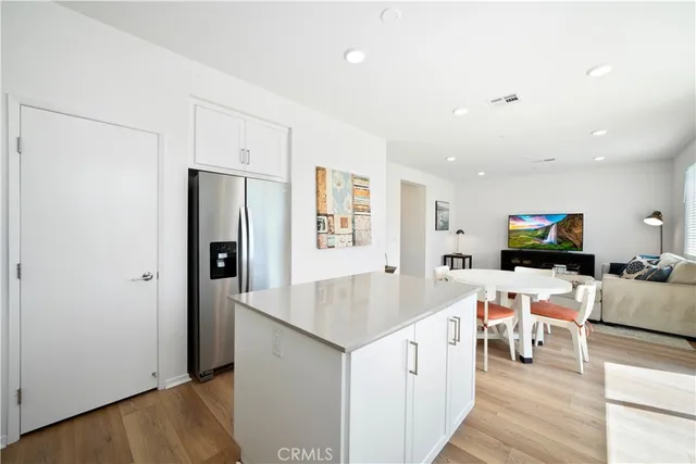 a view of living room kitchen with stainless steel appliances furniture stove and refrigerator