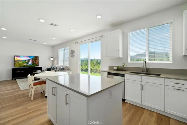 a kitchen with stainless steel appliances granite countertop a sink and a stove