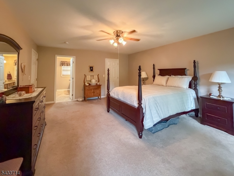 29 Lark Lane Oak Ridge, NJ 07438 - Photo 16 of 26 a spacious bedroom with a bed and a chandelier