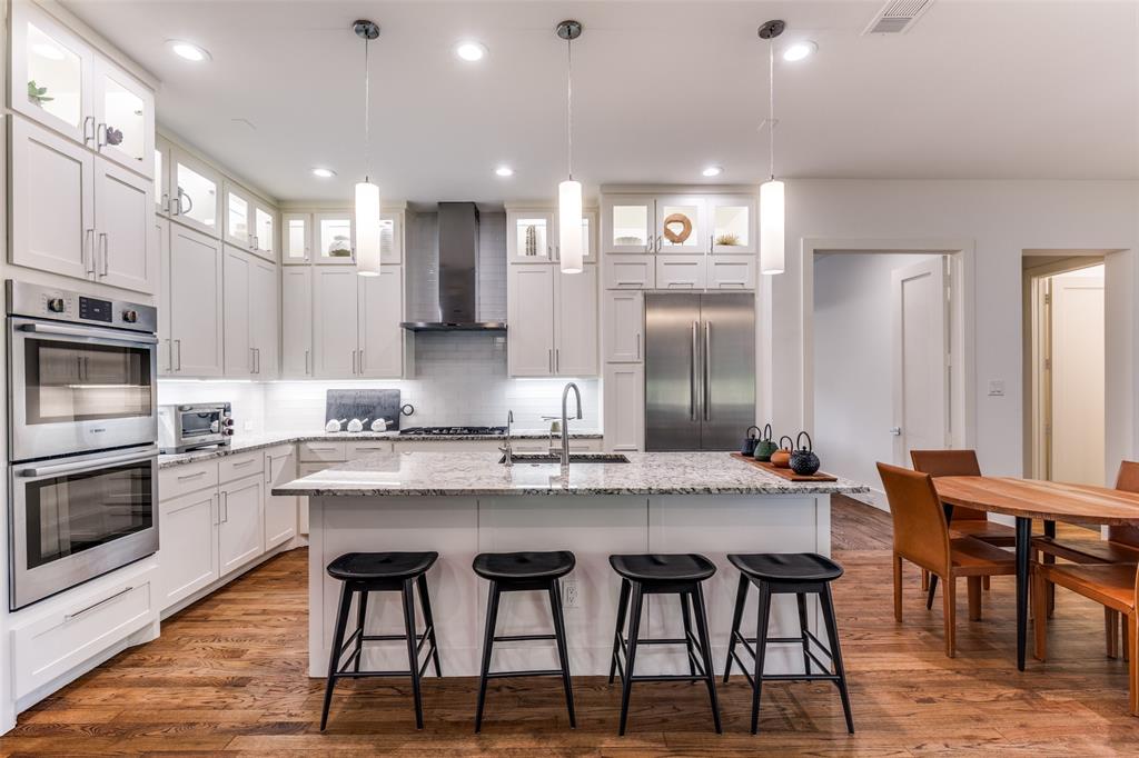 3755 Northview Lane Dallas, TX 75229 - Photo 11 of 36 a kitchen with stainless steel appliances kitchen island granite countertop a dining table chairs sink and cabinets