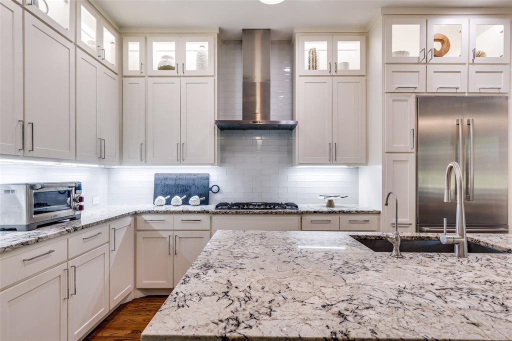 3755 Northview Lane Dallas, TX 75229 - Photo 12 of 36 a kitchen with stainless steel appliances granite countertop a refrigerator a sink and white cabinets