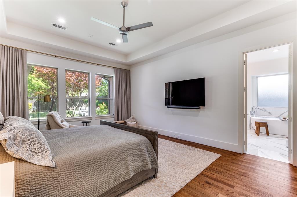3755 Northview Lane Dallas, TX 75229 - Photo 19 of 36 a spacious bedroom with a bed and a flat screen tv