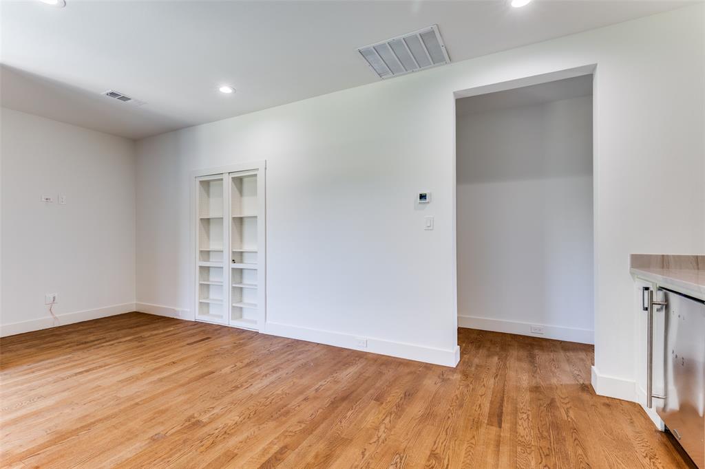 3755 Northview Lane Dallas, TX 75229 - Photo 29 of 36 an empty room with wooden floor and windows