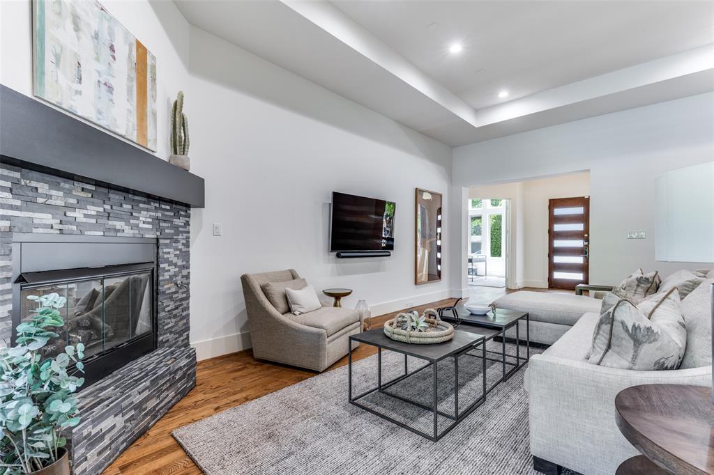 3755 Northview Lane Dallas, TX 75229 - Photo 8 of 36 a living room with furniture a flat screen tv and a fireplace