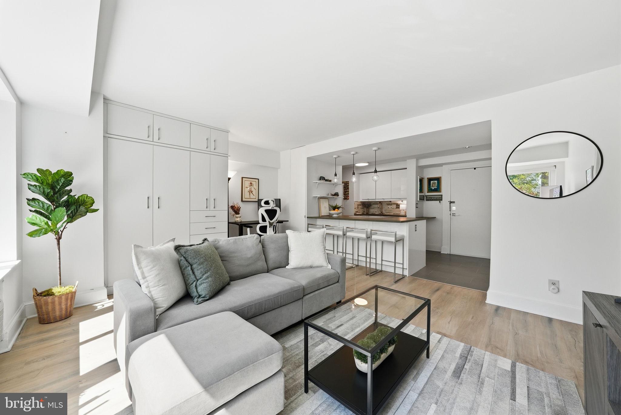 a living room with furniture and kitchen view