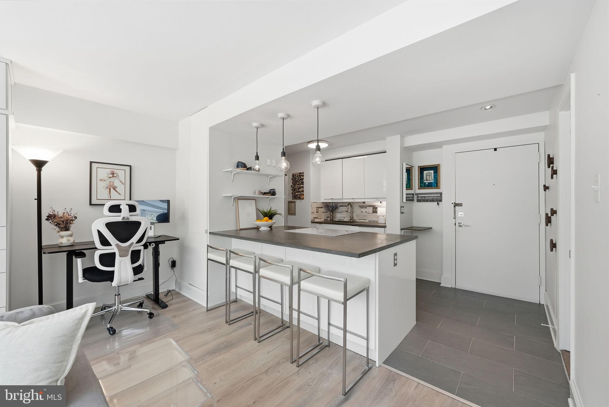 1825 T Street Northwest, Unit 207 Washington, DC 20009 - Photo 4 of 22 a kitchen with stainless steel appliances kitchen island a refrigerator sink and cabinets
