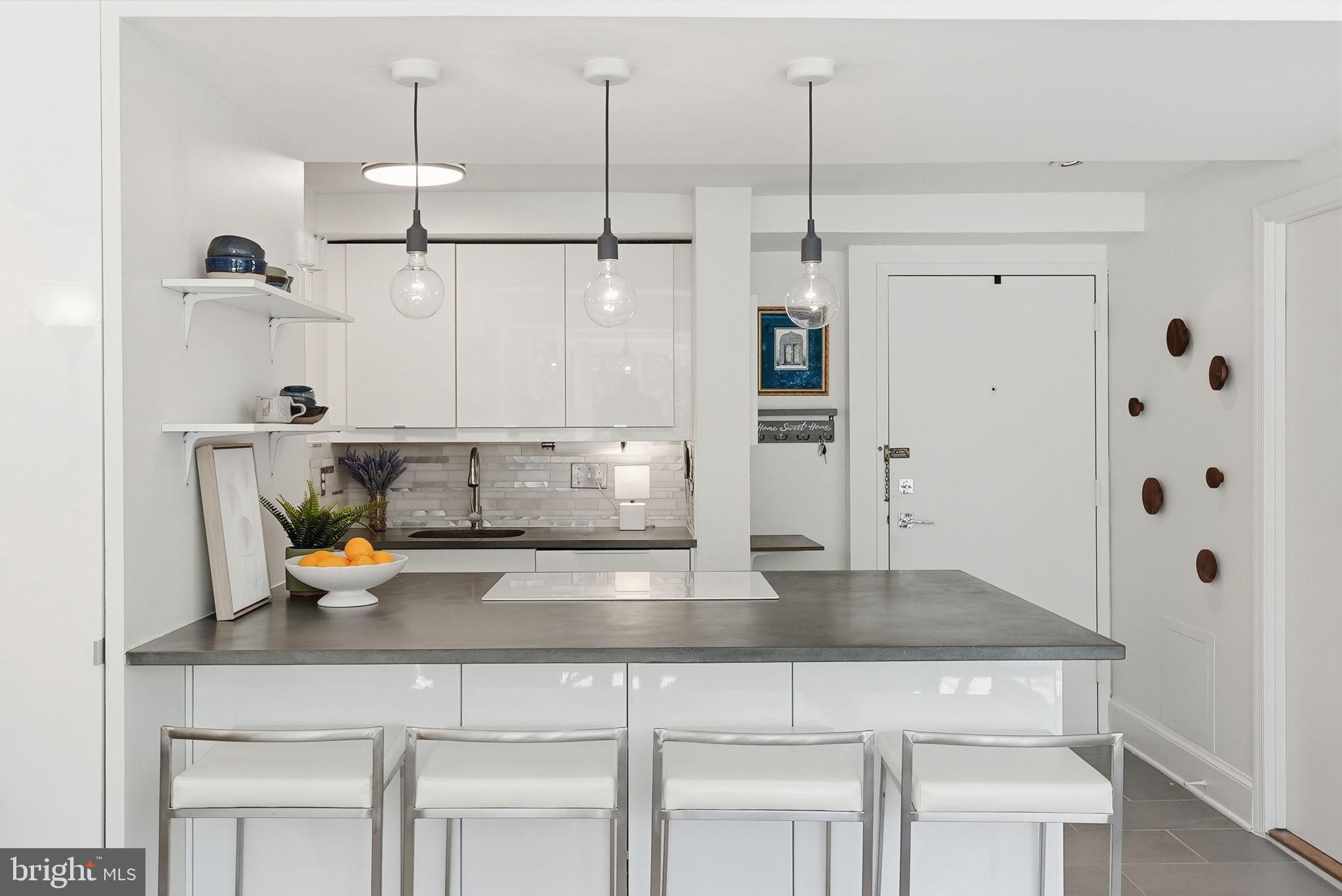 1825 T Street Northwest, Unit 207 Washington, DC 20009 - Photo 5 of 22 a kitchen with a refrigerator a sink and cabinets