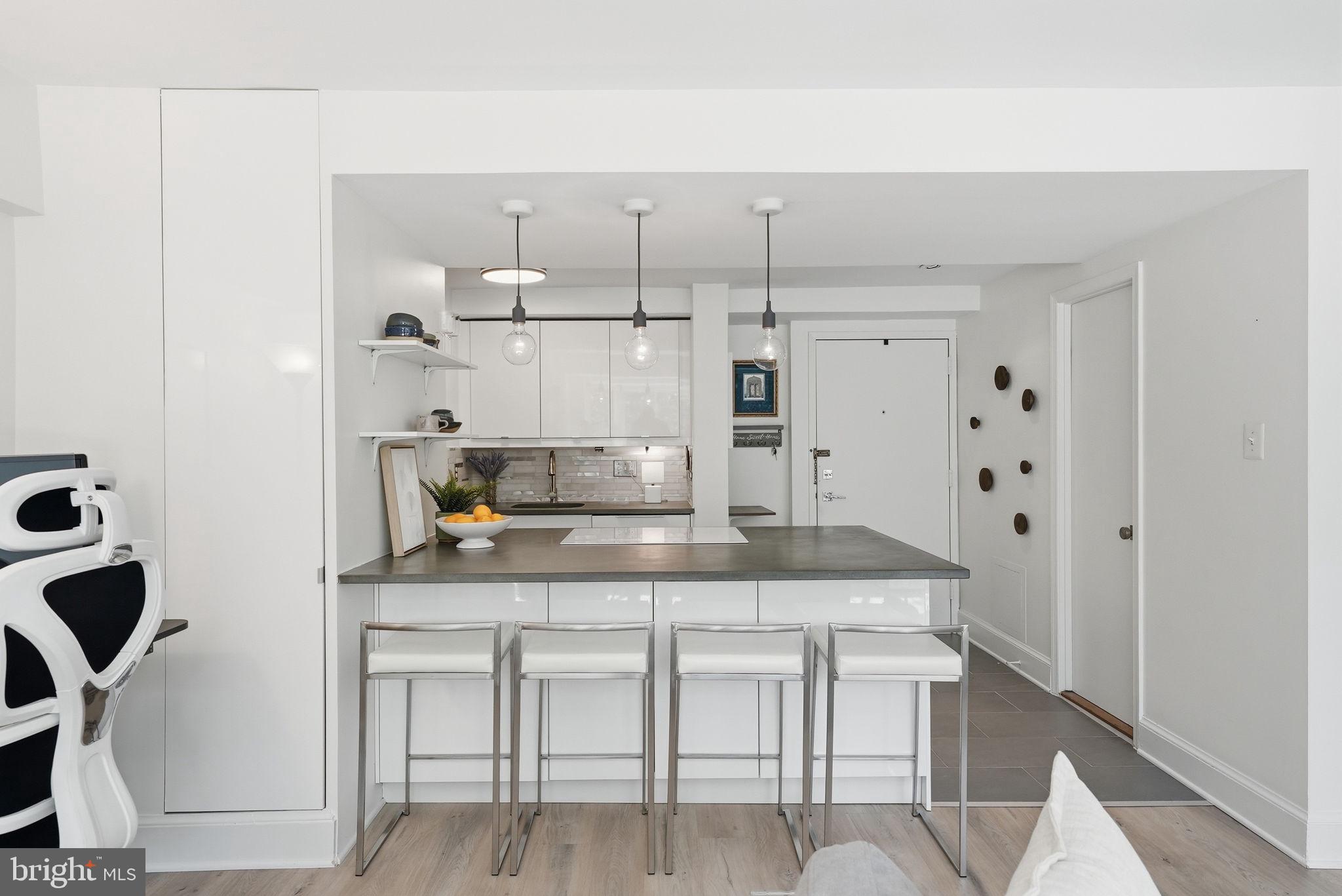 1825 T Street Northwest, Unit 207 Washington, DC 20009 - Photo 6 of 22 a kitchen with cabinets and chairs