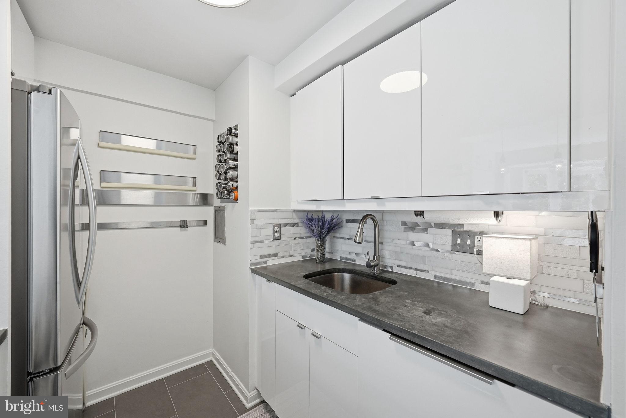 1825 T Street Northwest, Unit 207 Washington, DC 20009 - Photo 8 of 22 a kitchen with a refrigerator and a sink