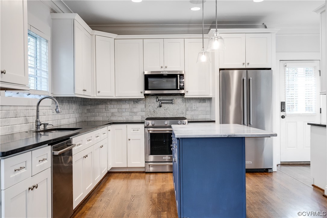 7203 Pinetree Road Henrico, VA 23229 - Photo 14 of 50 a kitchen with stainless steel appliances granite countertop a stove a sink dishwasher a refrigerator and white cabinets with wooden floor