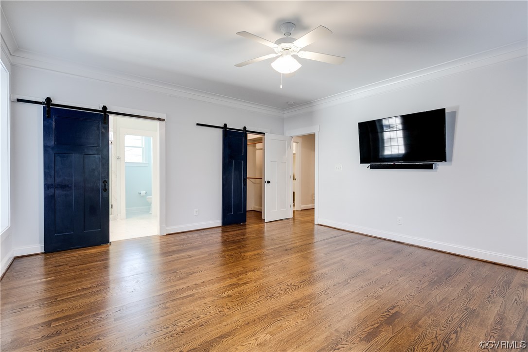 7203 Pinetree Road Henrico, VA 23229 - Photo 32 of 50 a view of a livingroom with a flat screen tv wooden floor and a ceiling fan
