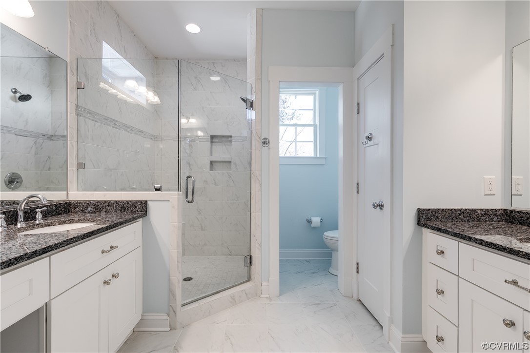 7203 Pinetree Road Henrico, VA 23229 - Photo 34 of 50 a spacious bathroom with a granite countertop sink mirror and shower