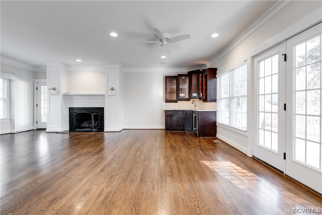7203 Pinetree Road Henrico, VA 23229 - Photo 6 of 50 an empty room with wooden floor fireplace and windows